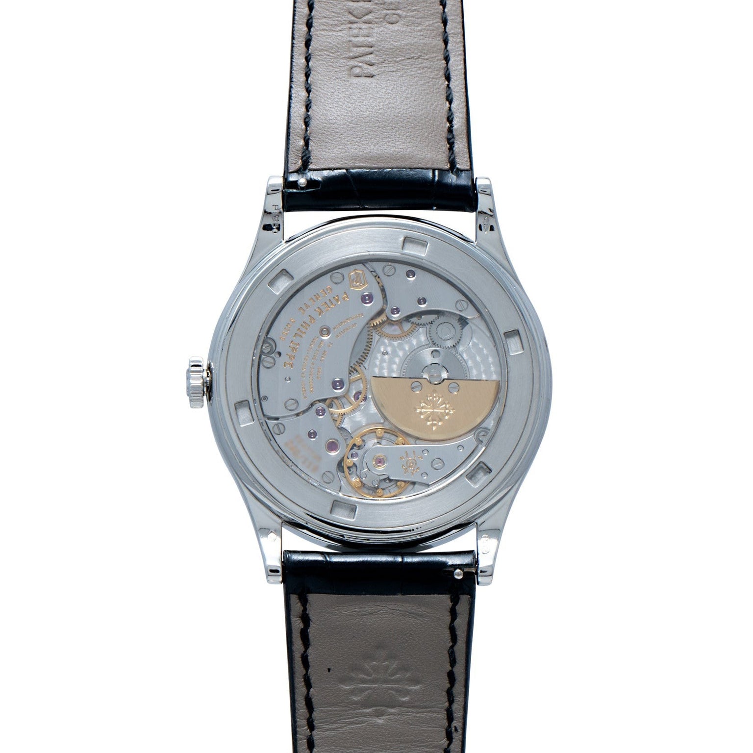 Back view of the Patek Philippe Calatrava Cloisonné Iris & Night Fireflies watch, showcasing its visible mechanical movement and black leather strap.