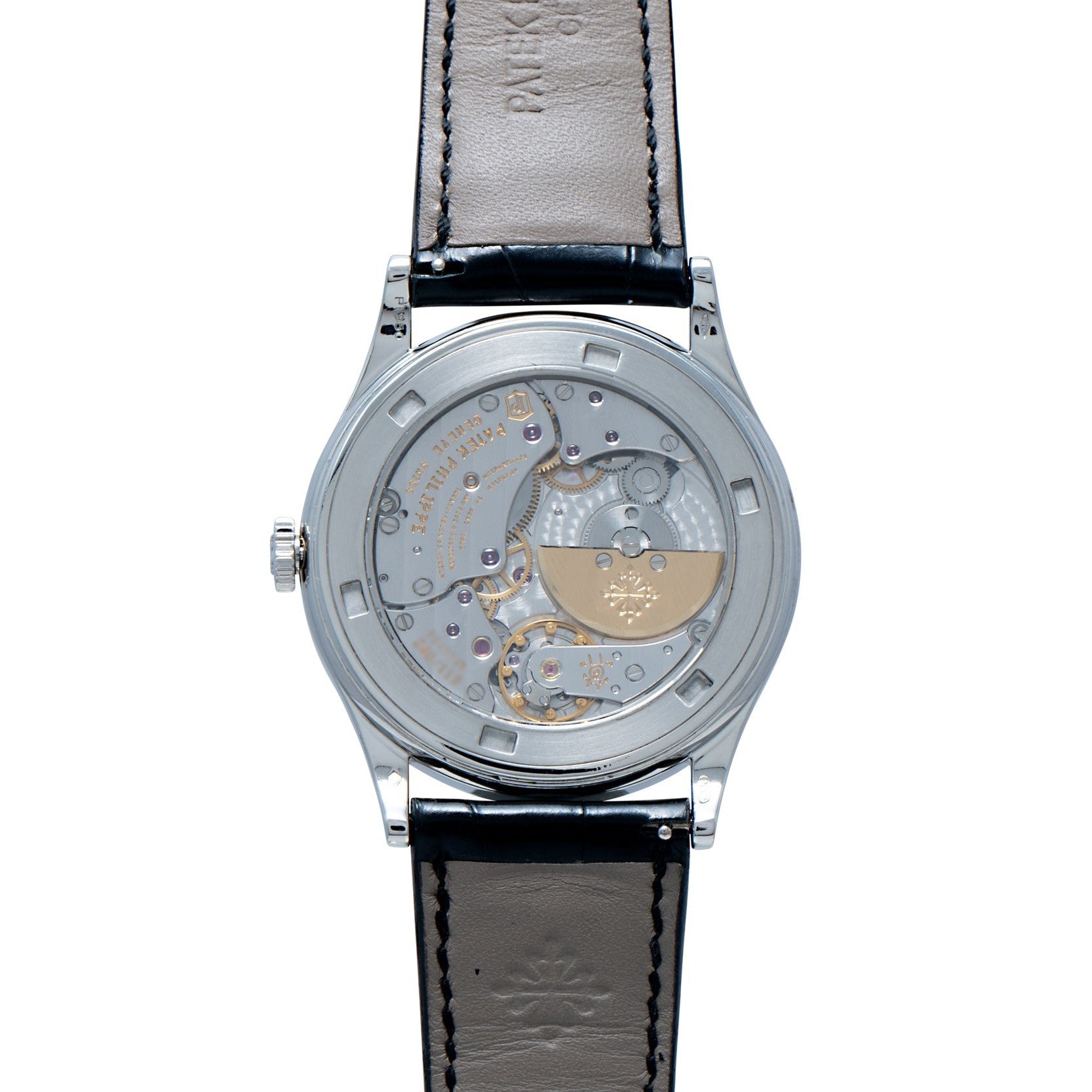 Back view of the Patek Philippe Calatrava Cloisonné Iris & Night Fireflies watch, showcasing its visible mechanical movement and black leather strap.