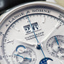 Close-up of a Lange & Sohne Datograph Perpetual Calendar watch face highlighting its detailed dials and date display.