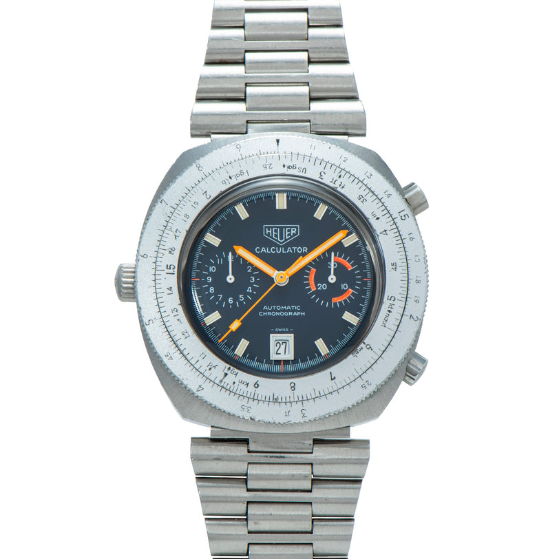 Heuer Calculator stainless steel chronograph watch with dark dial, yellow hands, and linked metal bracelet.