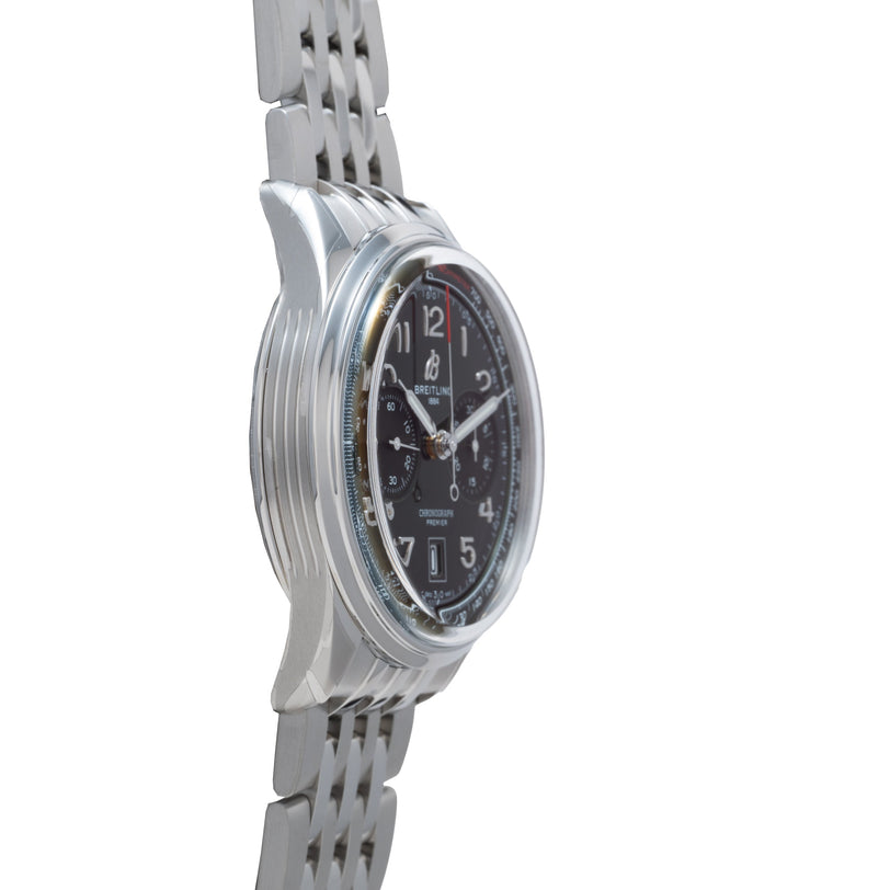Silver stainless steel chronograph watch with black dial, Arabic numerals, and three subdials on linked metal bracelet.