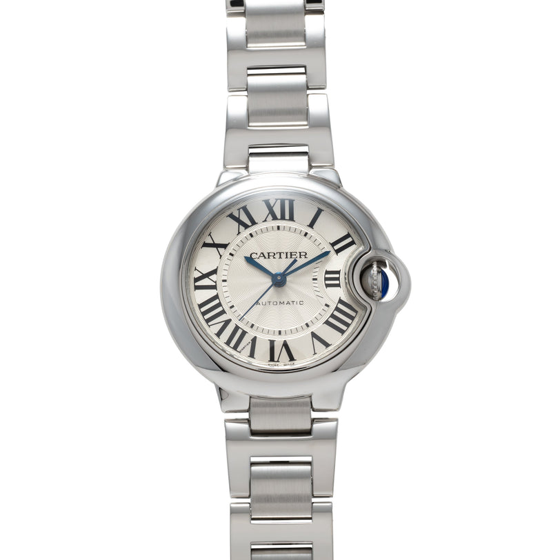 Stainless steel watch with cream dial, Roman numerals, blue hands, crown with blue cabochon, and matching steel bracelet.