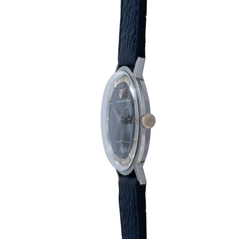 Nivada Grenchen Sub Seconds watch with dark dial, metal case, and navy fabric strap shown from side view.