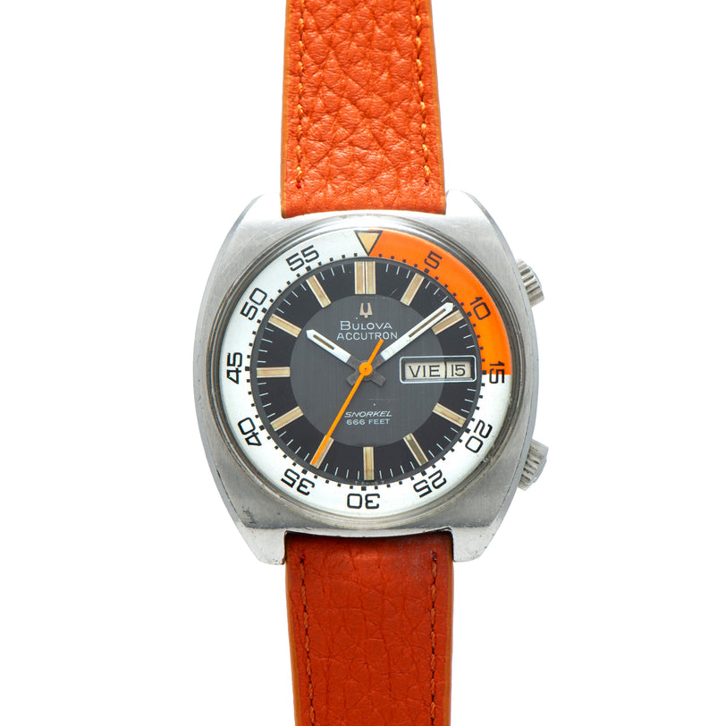 Bulova Accutron Snorkel diver watch with stainless steel case, black dial, orange bezel, and orange leather strap.
