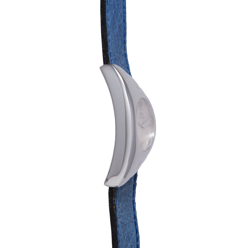 Silver curved watch with denim and black fabric strap, shown from front view.