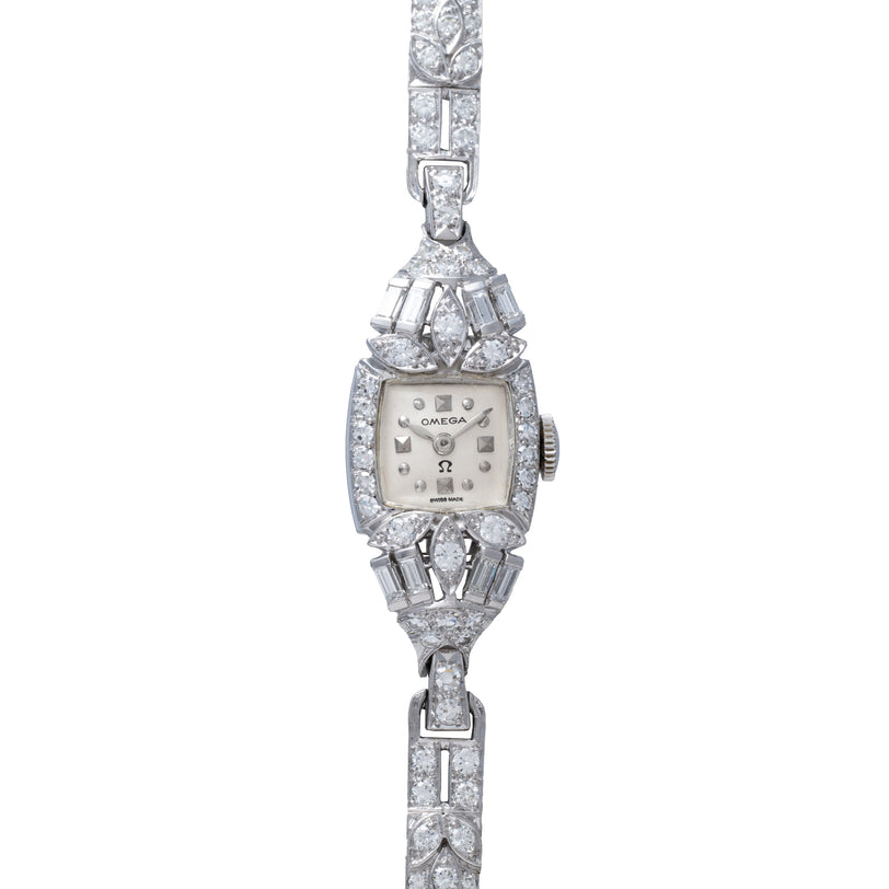 White gold Omega ladies' cocktail watch with square dial, diamond-set bezel, and matching diamond-encrusted bracelet.