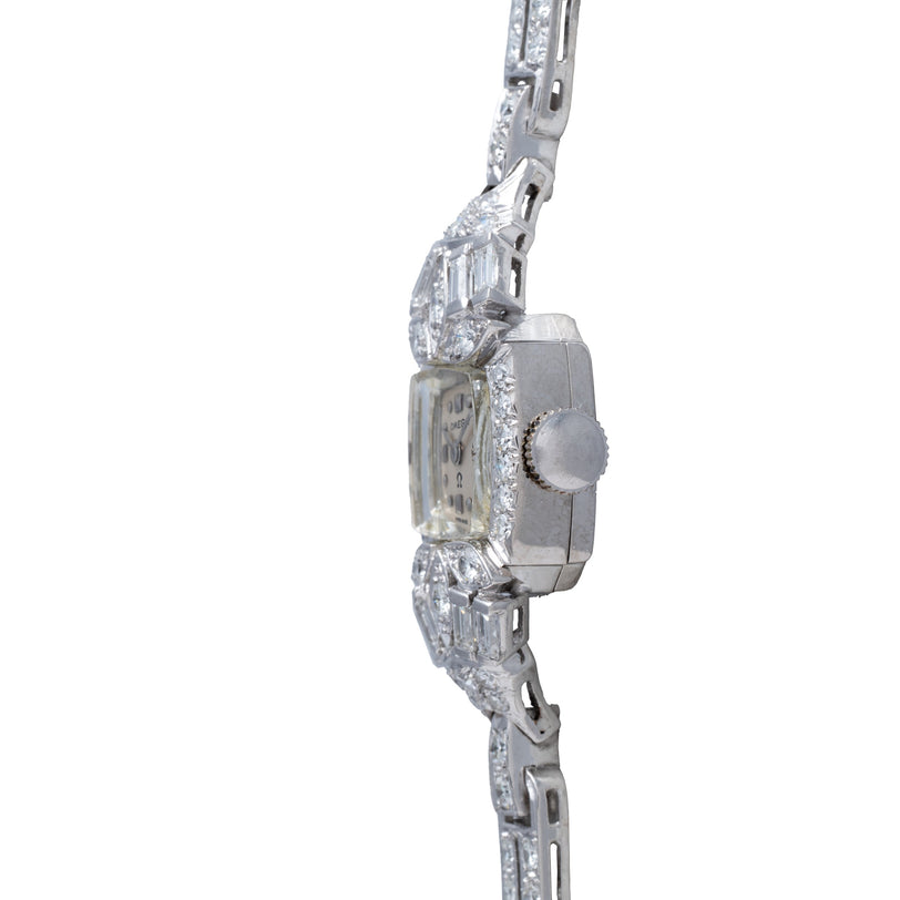 Silver-tone ladies' watch with rectangular case, crystal-embellished bezel and bracelet, and silver dial.