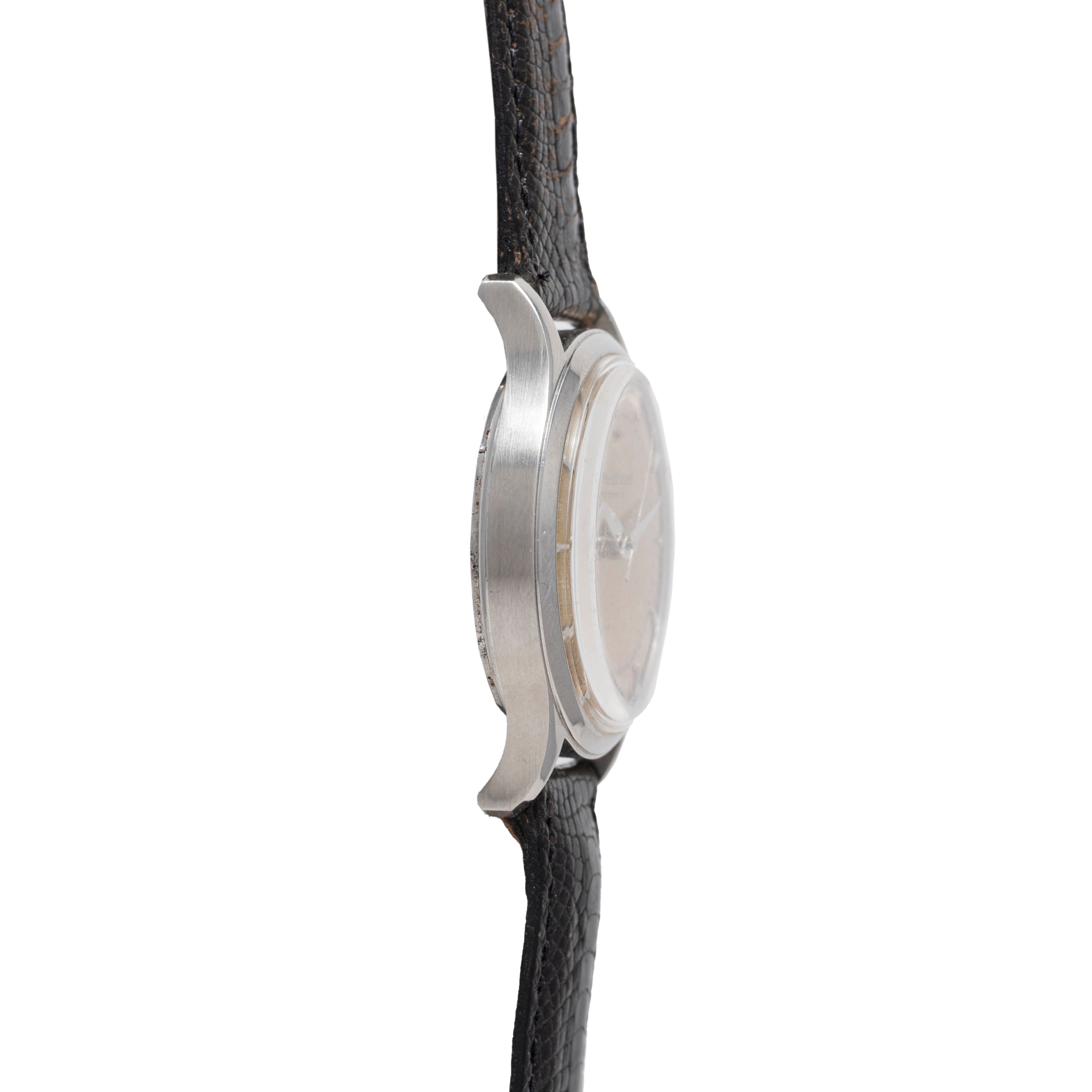 Side view of a Jaeger LeCoultre 'European Market' Powermatic dress watch, showing the round silver case and textured black leather strap, with focus on the case thickness and lugs; the watch face is not visible.