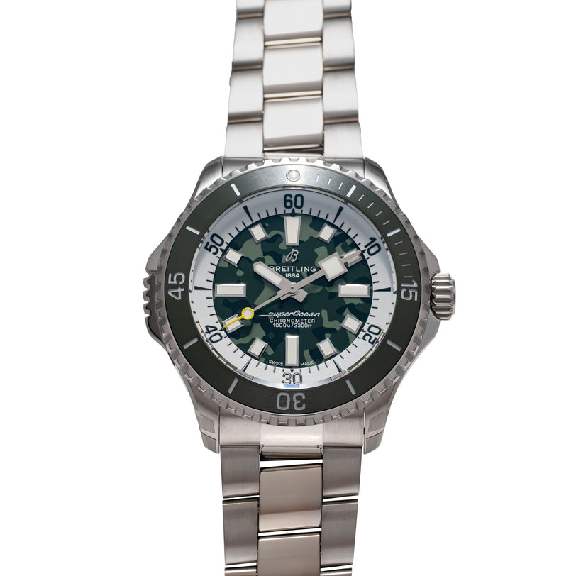 Stainless steel dive watch with dark blue dial, black rotating bezel, white hour markers, and three-link metal bracelet.