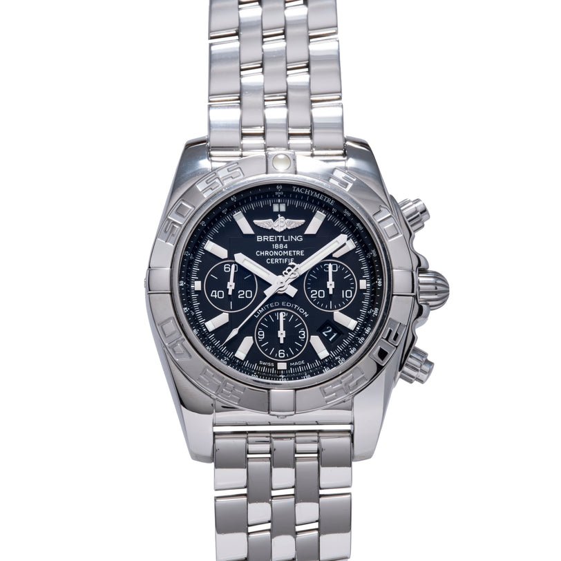Stainless steel chronograph watch with black dial, multiple subdials, tachymeter bezel, and matching metal bracelet.