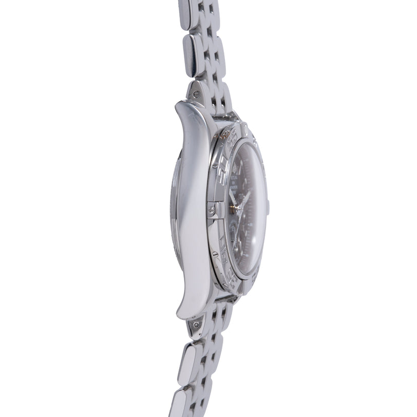 Steel chronograph watch with dark dial displayed on matching steel bracelet, side profile view.