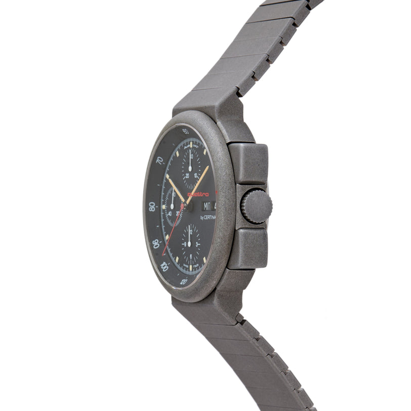 Gray chronograph watch with black dial, multiple subdials, red accents, and matching gray metal bracelet.
