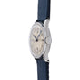 The Movado 'Calatrava' Steel showcases a round silver case, cream dial with black numerals, and blue leather strap—an elegant tribute to Swiss watchmaking, seen from the side on a white background.