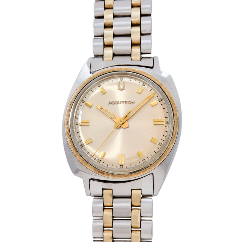 Bulova Accutron watch with two-tone stainless steel and gold bracelet, cream dial, gold hour markers and hands.