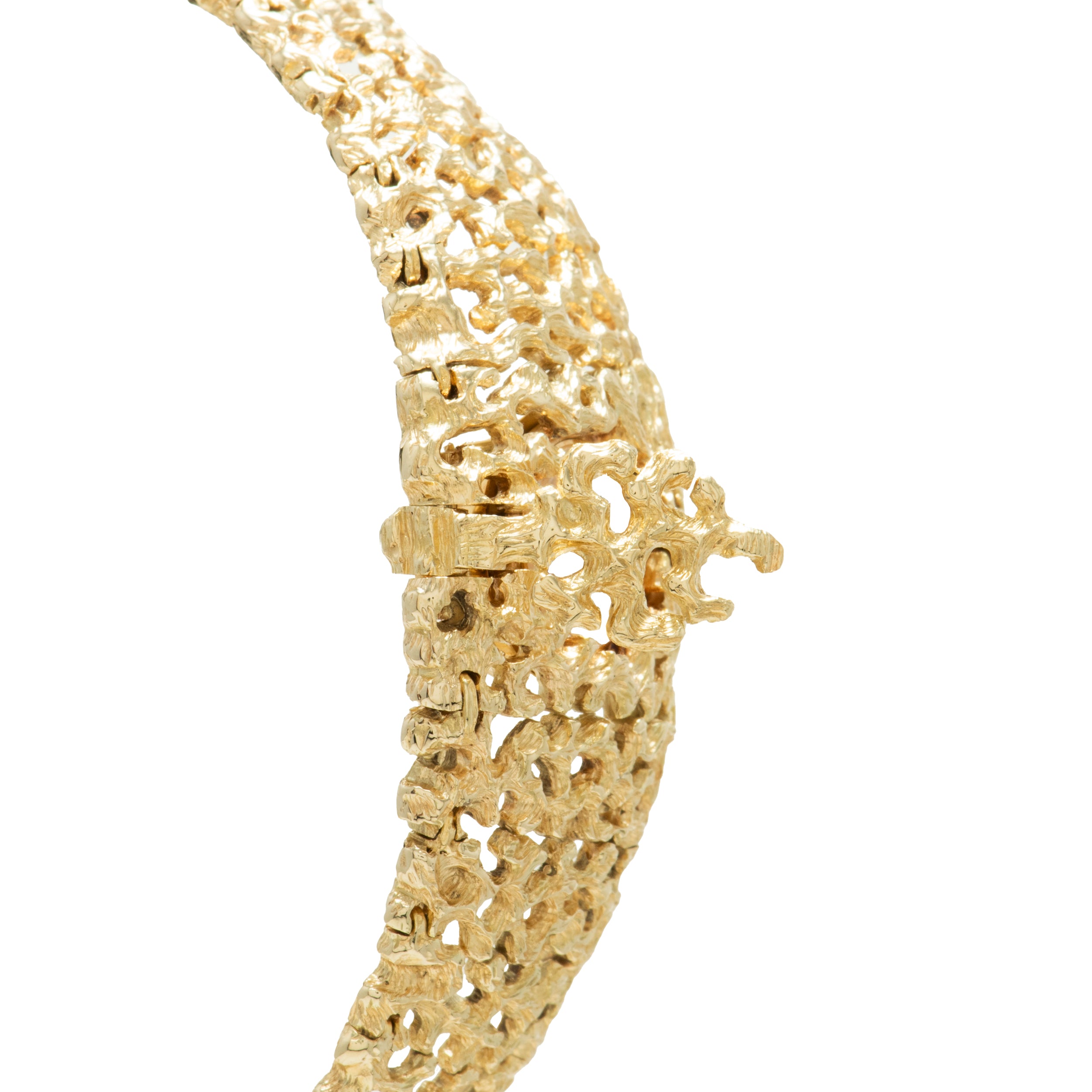 Gold openwork bracelet watch with ornate filigree design and textured surface throughout band and case.