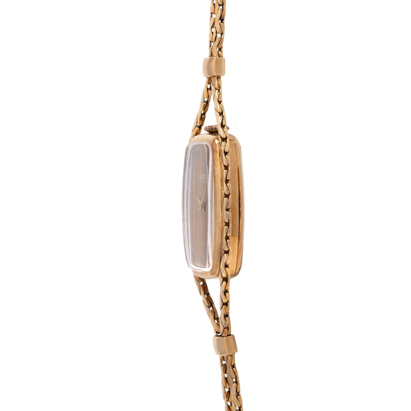Gold-tone chain necklace with rectangular watch pendant featuring tiger's eye stone and metallic case.