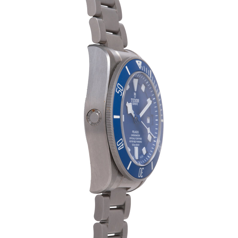 Tudor Pelagos dive watch with blue dial and bezel, stainless steel case and bracelet, shown from the side.