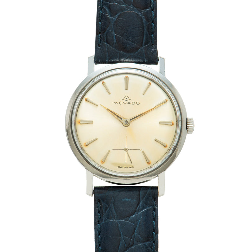 Movado Sub Sea watch with cream dial, gold-tone indices, and dark blue crocodile leather strap.