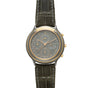 Two-tone chronograph watch with dark gray dial, three subdials, date window, and crocodile leather strap with white stitching