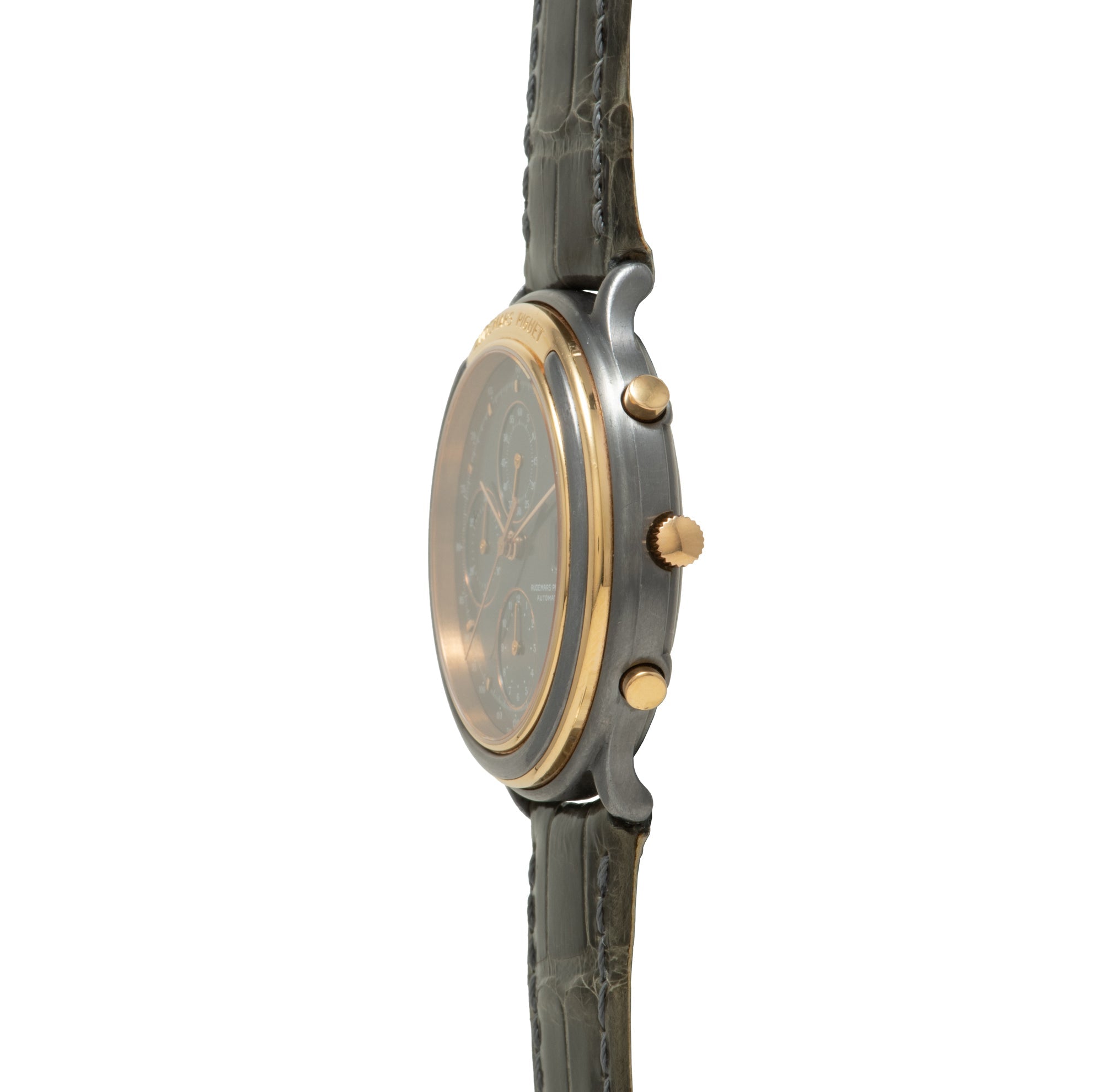 Luxury chronograph watch with dark dial, two-tone case in steel and gold, three subdials, and gray leather strap.