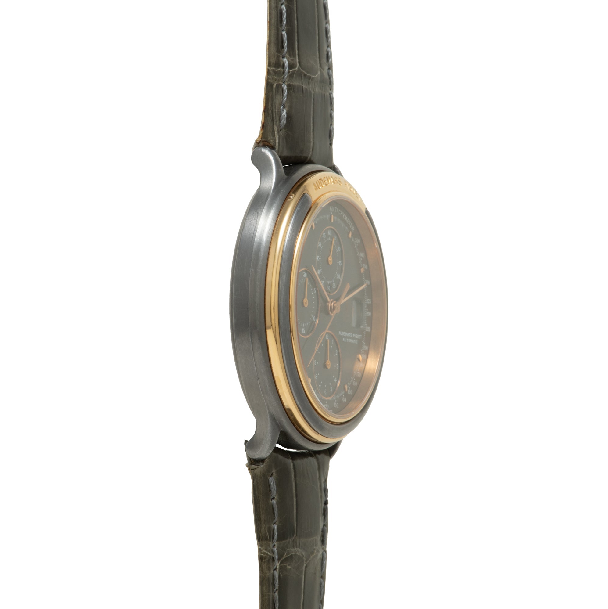 Steel and gold chronograph watch with dark dial, multiple subdials, and crocodile leather strap.