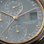 Audemars Piguet chronograph watch dial with gray face, multiple subdials, rose gold hands, and tachymeter scale.