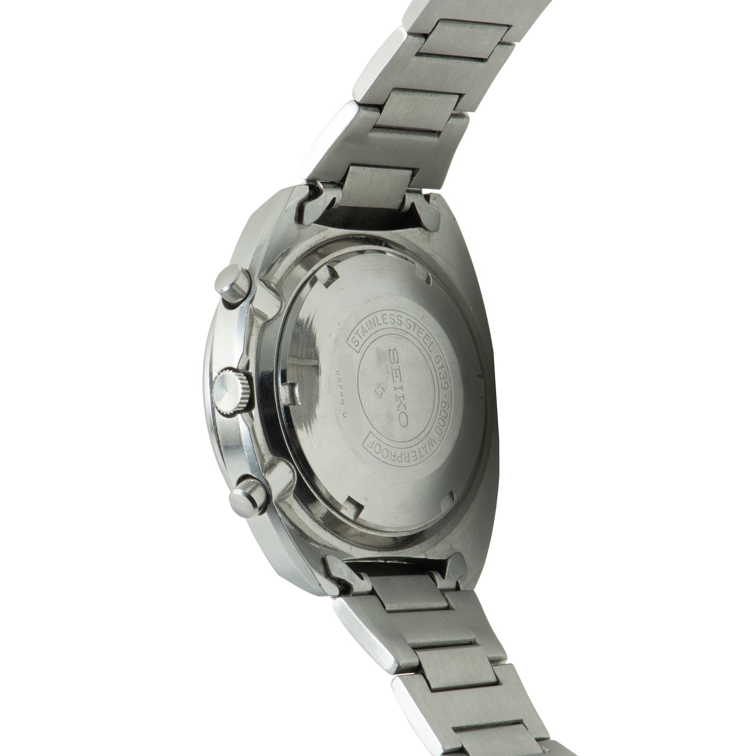 Seiko chronograph watch with stainless steel case and bracelet, shown from rear view displaying caseback with engraved text.