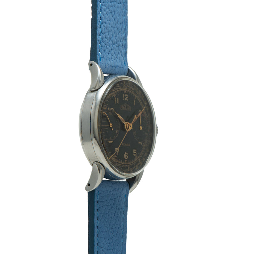 Angelus chronograph watch with dark dial, Arabic numerals, and blue leather strap.