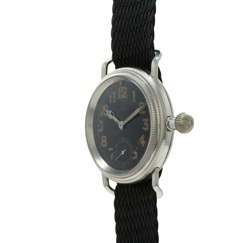 Silver-tone watch with black dial, Arabic numerals, subsidiary seconds dial, and black fabric strap.