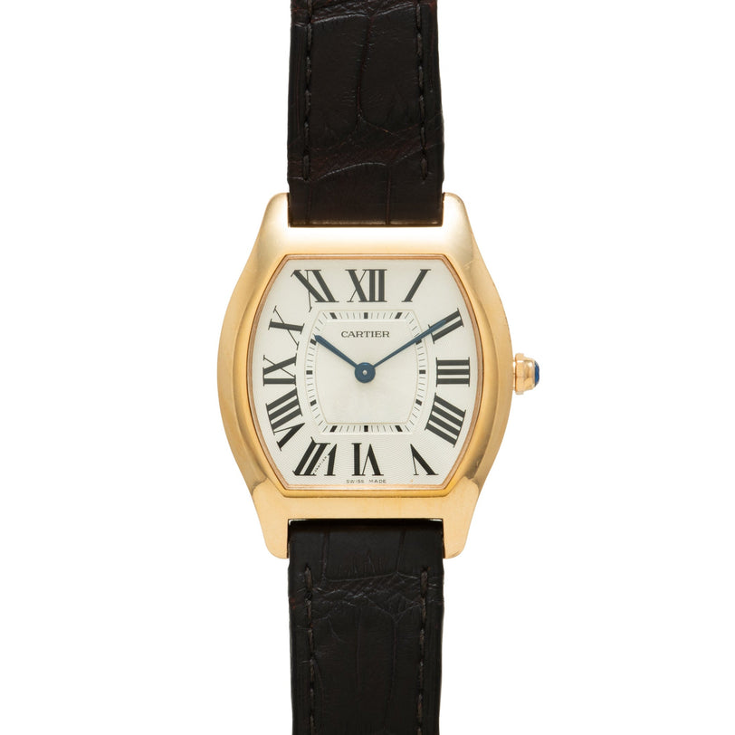 Gold-tone Cartier Tortue watch with cream dial, Roman numerals, and black crocodile leather strap.