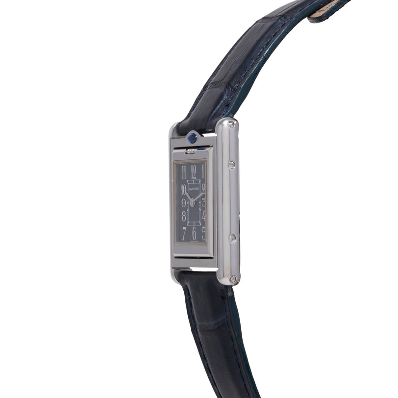 Cartier Tank Basculante with rectangular stainless steel case, black dial, and dark blue leather strap.