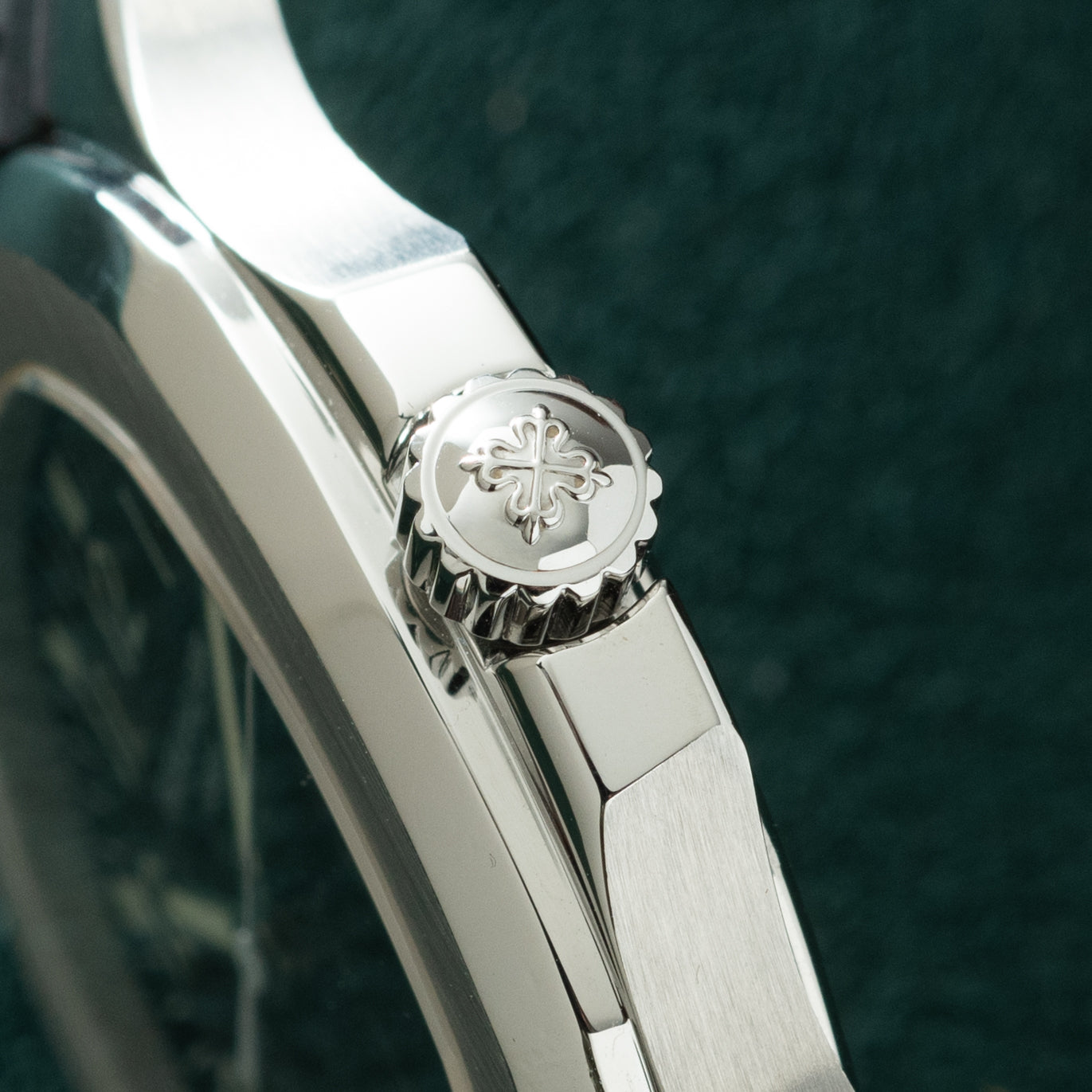 Silver-tone sports watch with octagonal bezel featuring cross motif and white rubber strap.