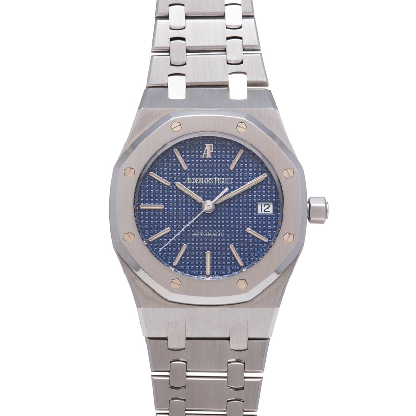 Stainless steel watch with deep blue dial, applied indices, date window, and matching metal bracelet.