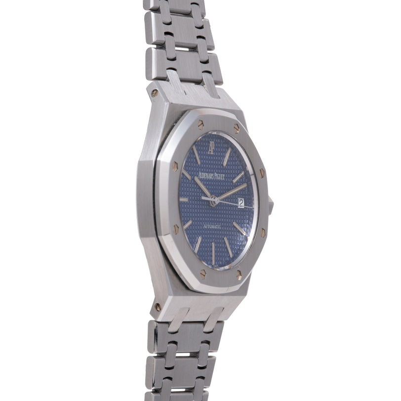 Stainless steel watch with deep blue dial, applied indices, date window, and matching metal bracelet.
