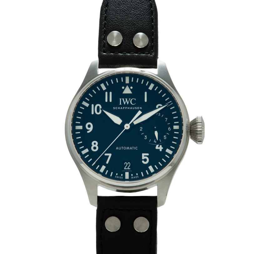 IWC Big Pilot watch with dark blue dial, Arabic numerals, white hands, steel case, and black leather strap with metal studs.