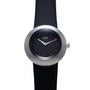 Ikepod watch with brushed metal case, black dial featuring orange dot markers, white hands, and black rubber strap.