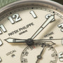 Patek Philippe Calatrava Pilot Travel Time watch dial showing hour markers, hands, and subdials labeled "Home," "Local," and
