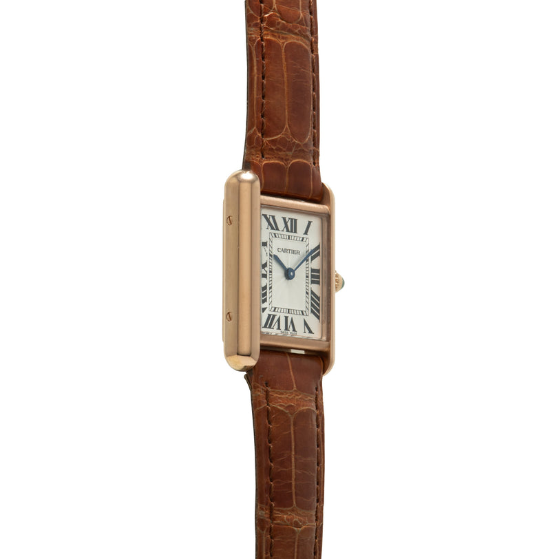 Gold-tone rectangular watch with cream dial, Roman numerals, and brown crocodile leather strap.