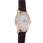 Gold-tone chronograph watch with white dial, Roman numerals, and dark brown leather strap.