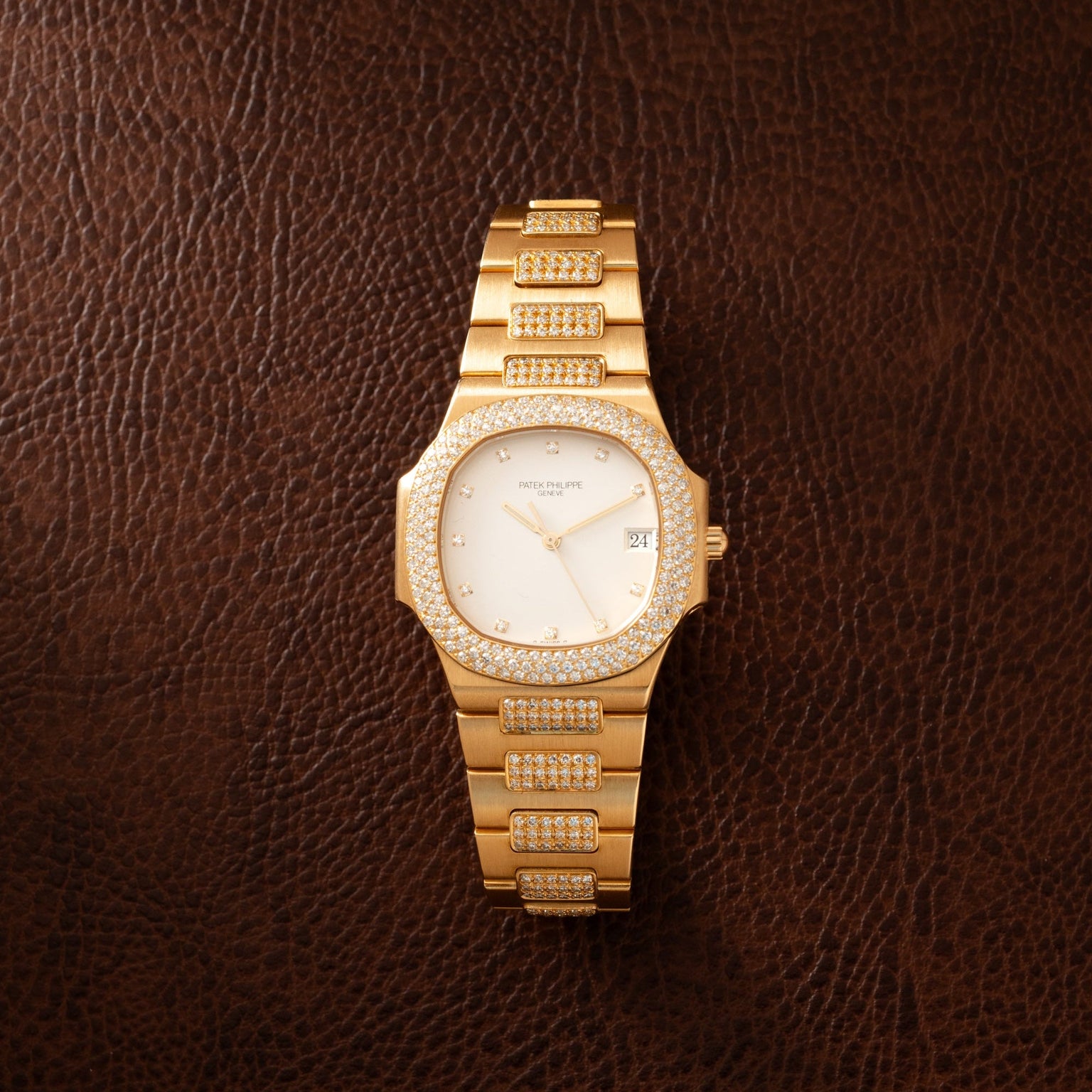 Gold-tone ladies watch with octagonal case, diamond-set bezel and bracelet, cream dial with date window.