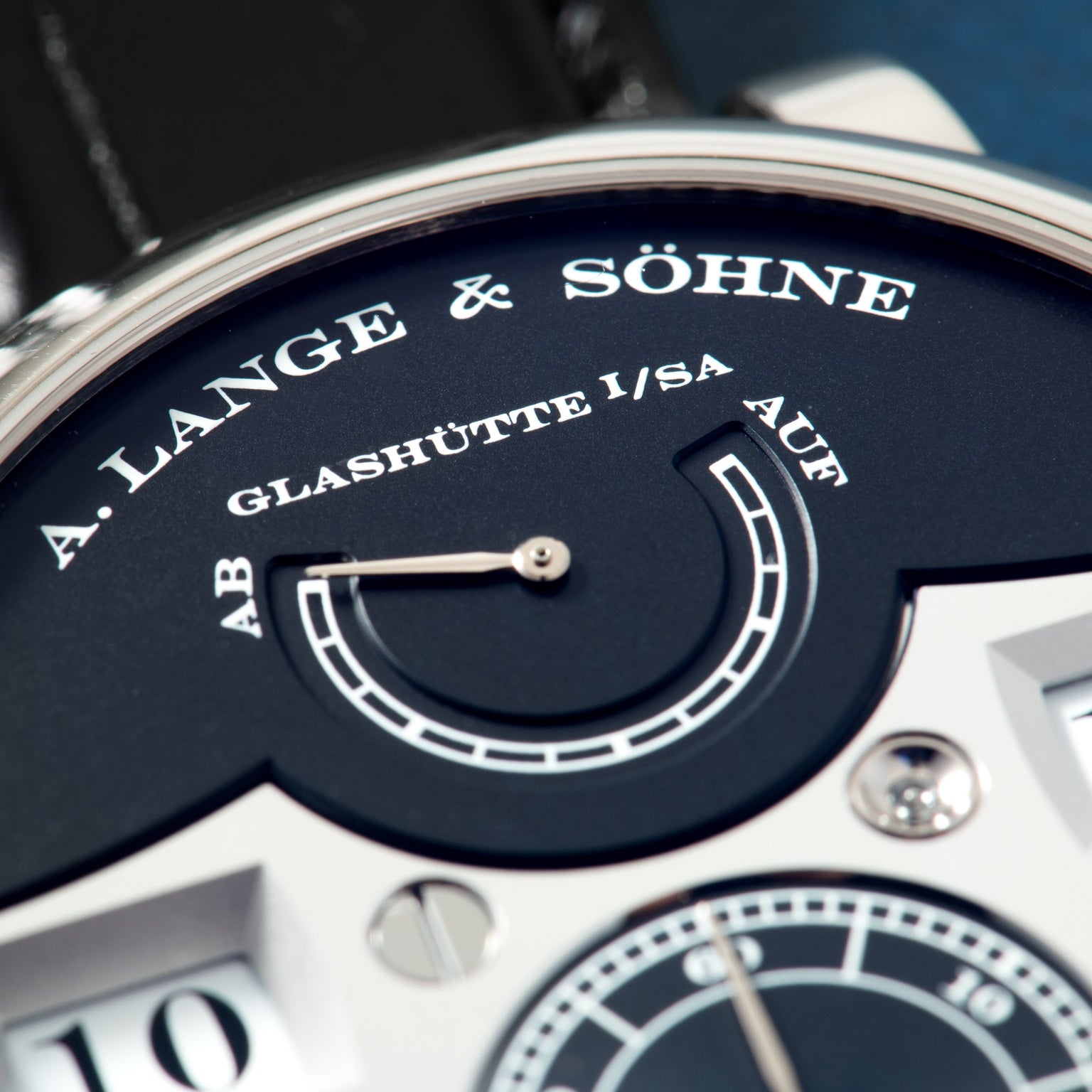 A. Lange & Söhne Zeitwerk watch with dark blue dial, digital time display, and black leather strap.