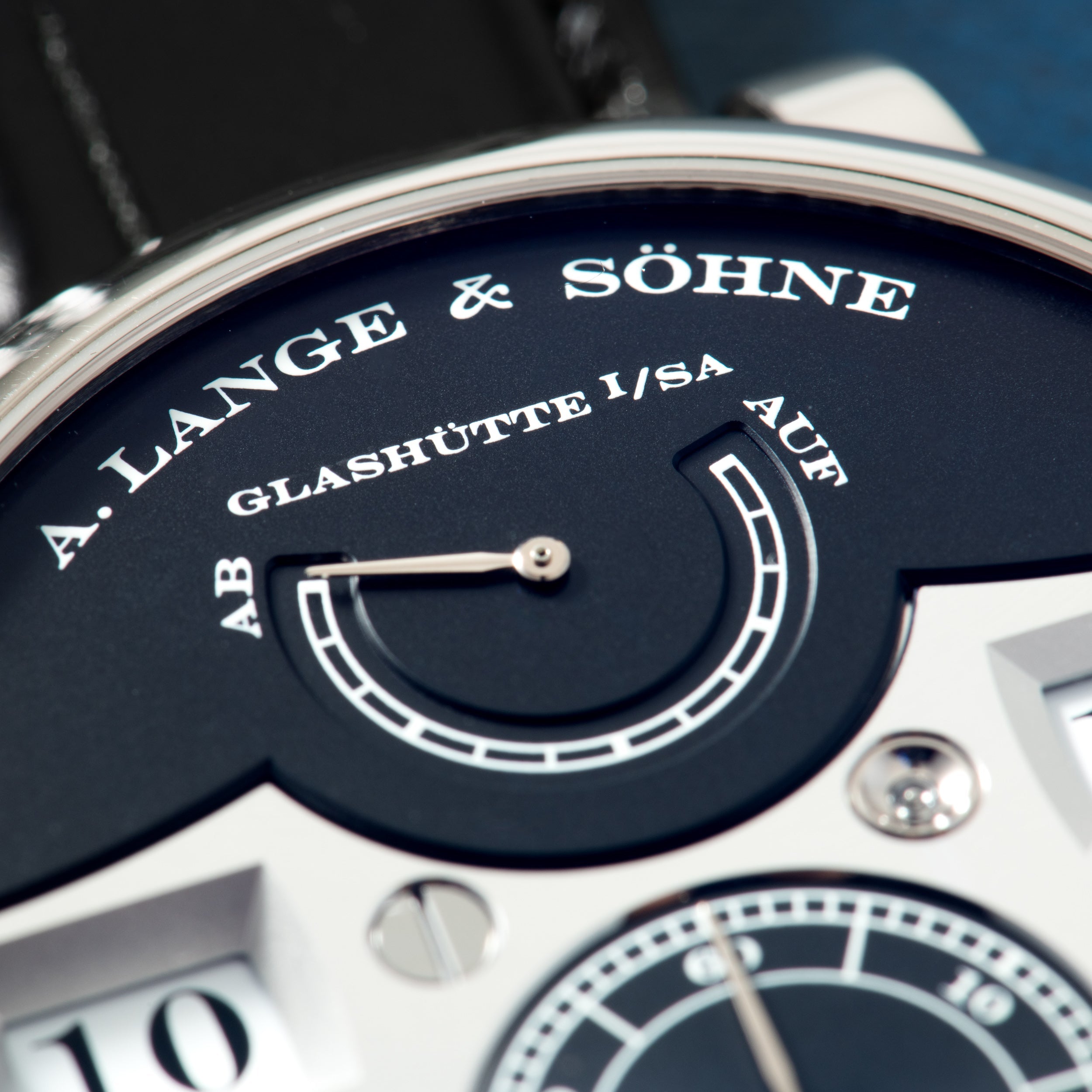 A. Lange & Söhne Zeitwerk watch with dark blue dial, digital time display, and black leather strap.