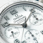 Omega Speedmaster chronograph watch face with white dial, tachymeter bezel, and multiple subdials.
