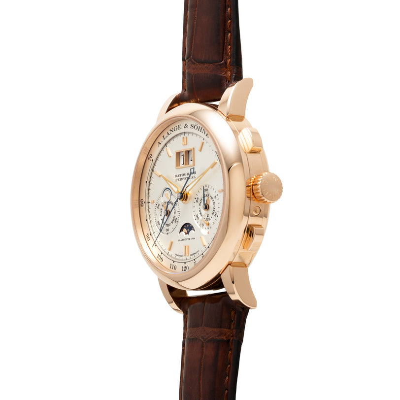 Rose gold watch with cream dial, multiple subdials, moon phase indicator, and brown leather strap.