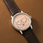 Silver-toned watch with cream dial, Roman numerals, circular subdial, and dark crocodile-textured leather strap.