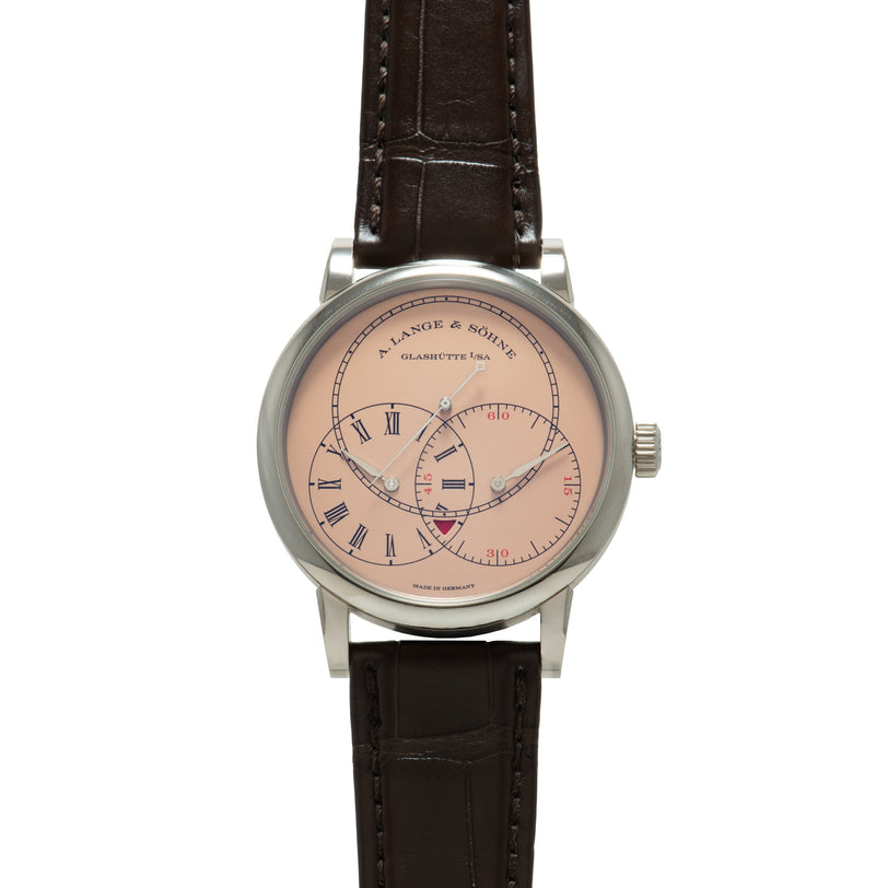 Silver-toned watch with salmon dial, Roman numerals, multiple subdials, and dark brown leather strap.
