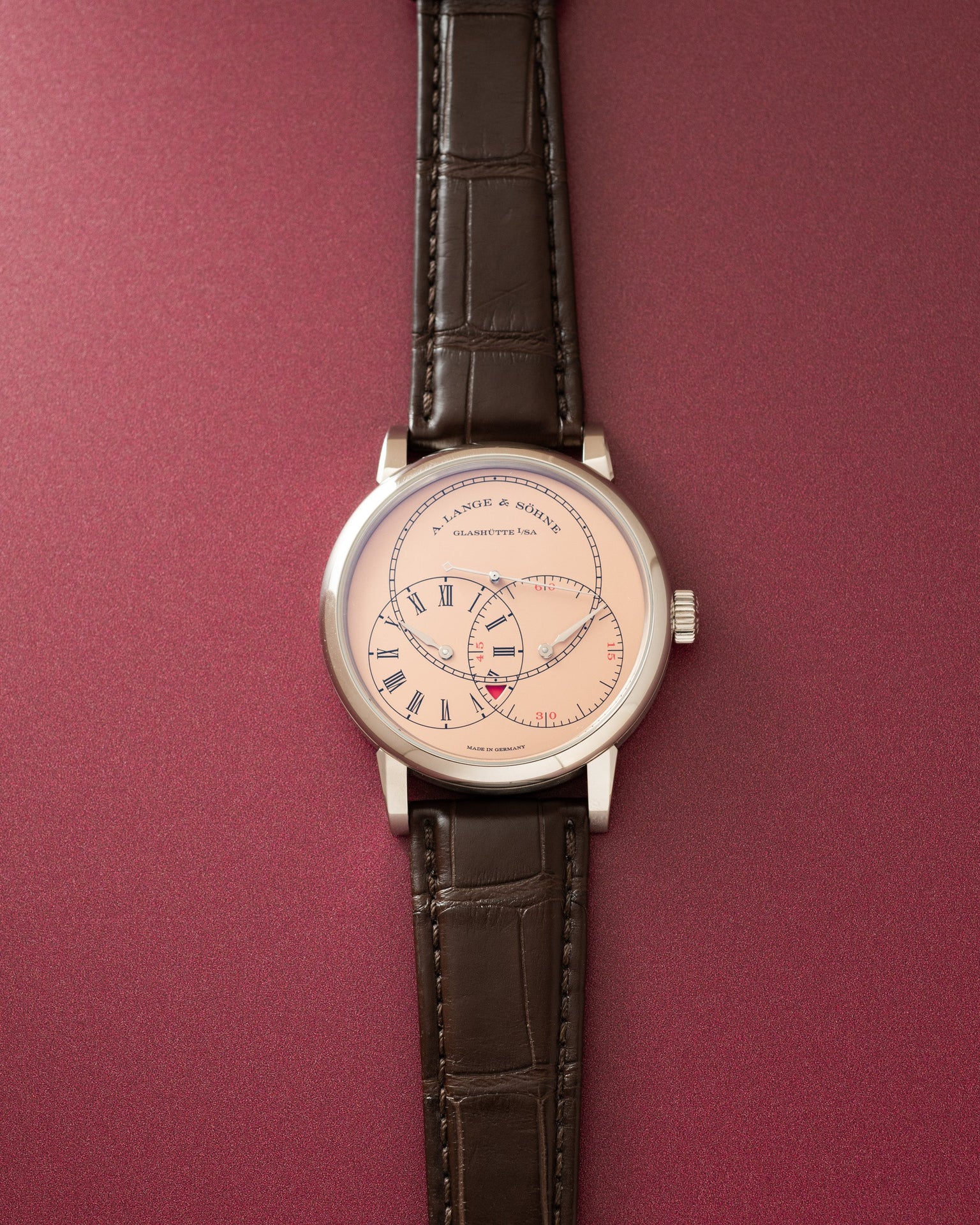 Silver-tone watch with cream dial, Roman numerals, dual subdials, and dark brown crocodile leather strap.