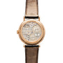 Rose gold round watch with visible movement through caseback, black leather strap, and exposed gears and balance wheel.