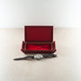 Chronograph watch with silver dial and black leather strap displayed with open burgundy presentation box.