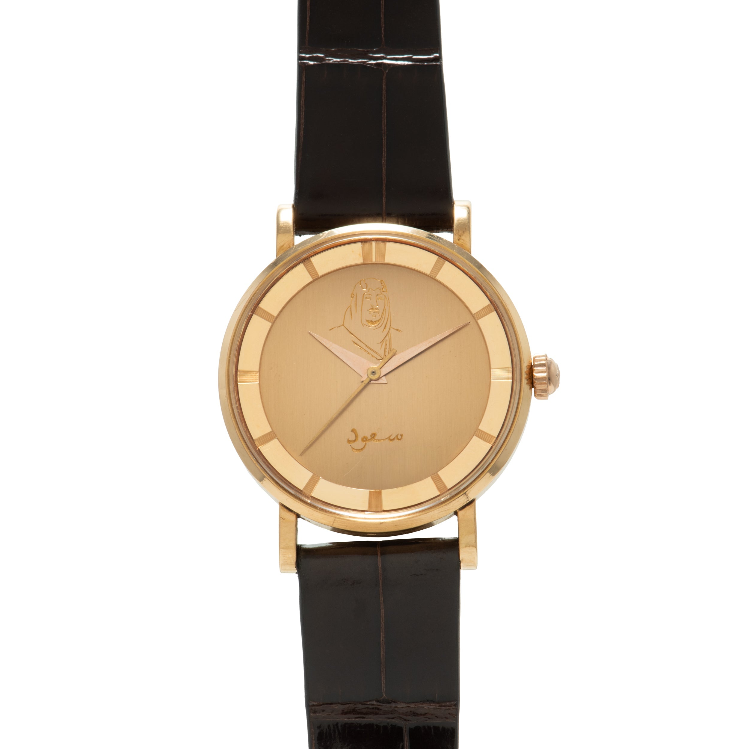Gold-tone Polerouter watch with champagne dial featuring portrait engraving and Arabic script, black leather strap.